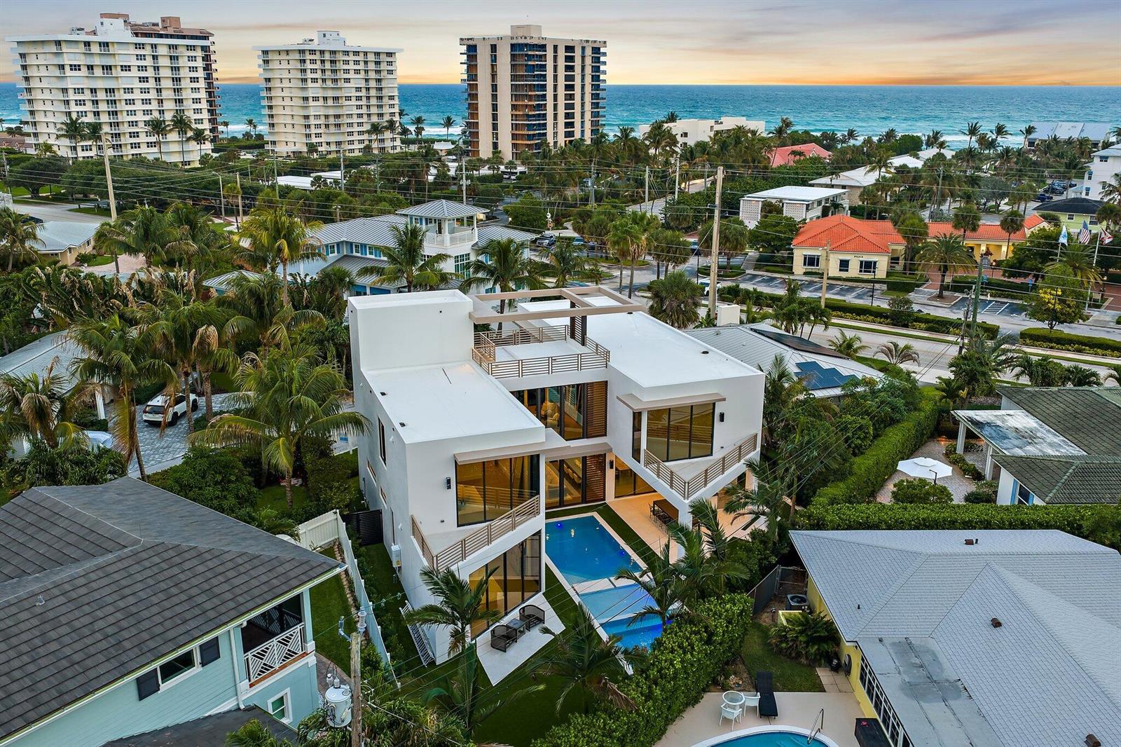 An aerial view of a modern white house with a pool and ocean view — 390 Jupiter Lane, Juno Beach FL 33408, JUNO BEACH, FL