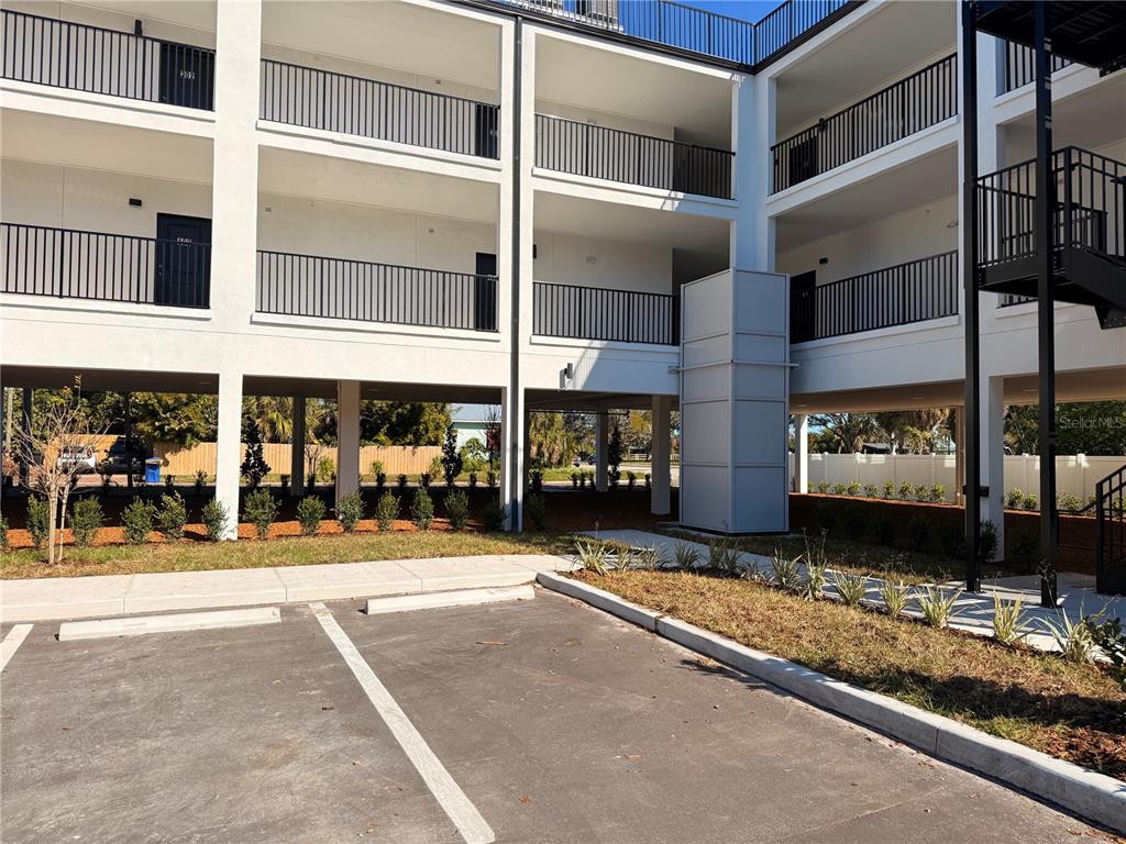 A multi-story apartment building with covered parking, exterior walkways, and a central elevator shaft — 3601 6TH STREET S, ST PETERSBURG, FL