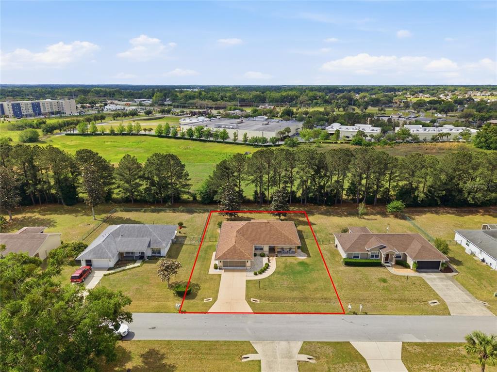 An aerial view shows a single-story house with a brown roof and driveway — 4772 NW 30TH PLACE, OCALA, FL