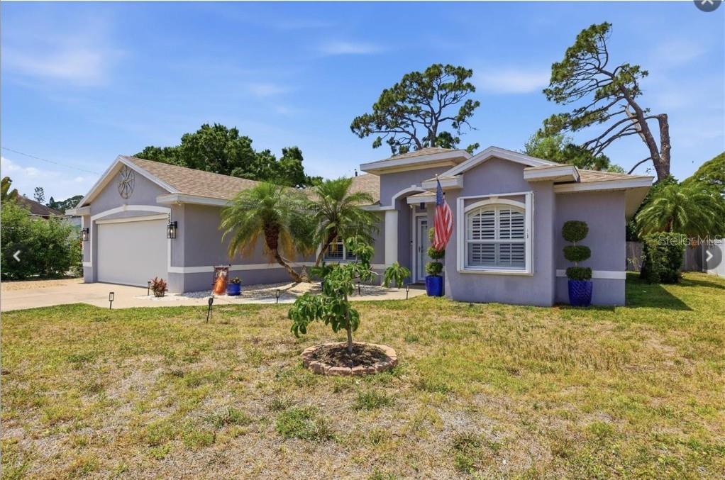 A single-story house with a gray exterior, a two-car garage, and a front lawn — 5948 ORCHIS ROAD, VENICE, FL