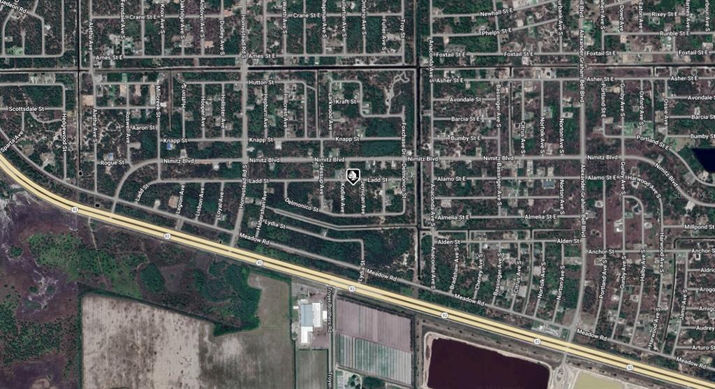 This is an aerial map view of a residential neighborhood with labeled streets — 656 LADD STREET, LEHIGH ACRES, FL
