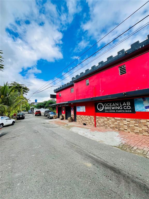 A bright red building with a crenelated roofline and an Ocean Lab Brewing Co. sign — 149 ROUTE UNIT KM 18.3, CIALES, PR