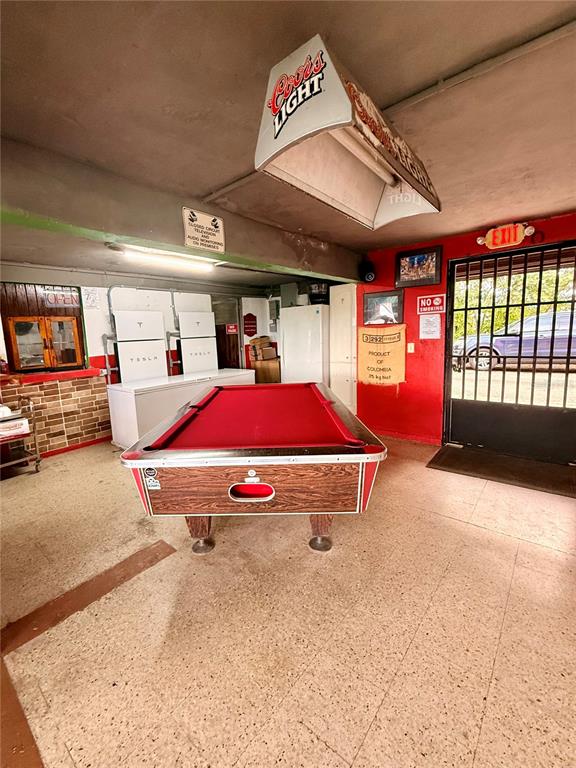 A pool table with a red felt top sits in a room with a Coors Light sign — 149 ROUTE UNIT KM 18.3, CIALES, PR