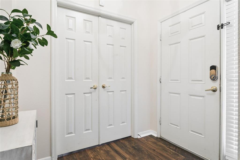 A white double-door closet and a white entry door with a smart lock — 2925 BANYAN HILL LANE, LAND O LAKES, FL