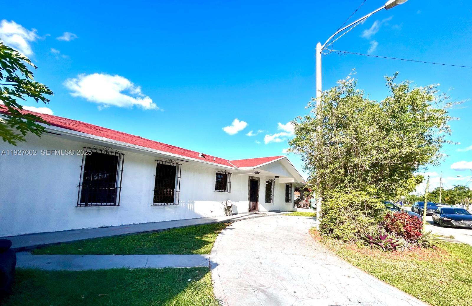 A white single-story house with a red roof and a curved concrete driveway — 598 SW 121st Ave, Miami FL 33184, MIAMI, FL
