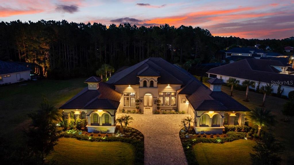 An aerial view of a luxury house with a paved driveway at sunset — 229 CONSERVATORY DRIVE, PALM COAST, FL