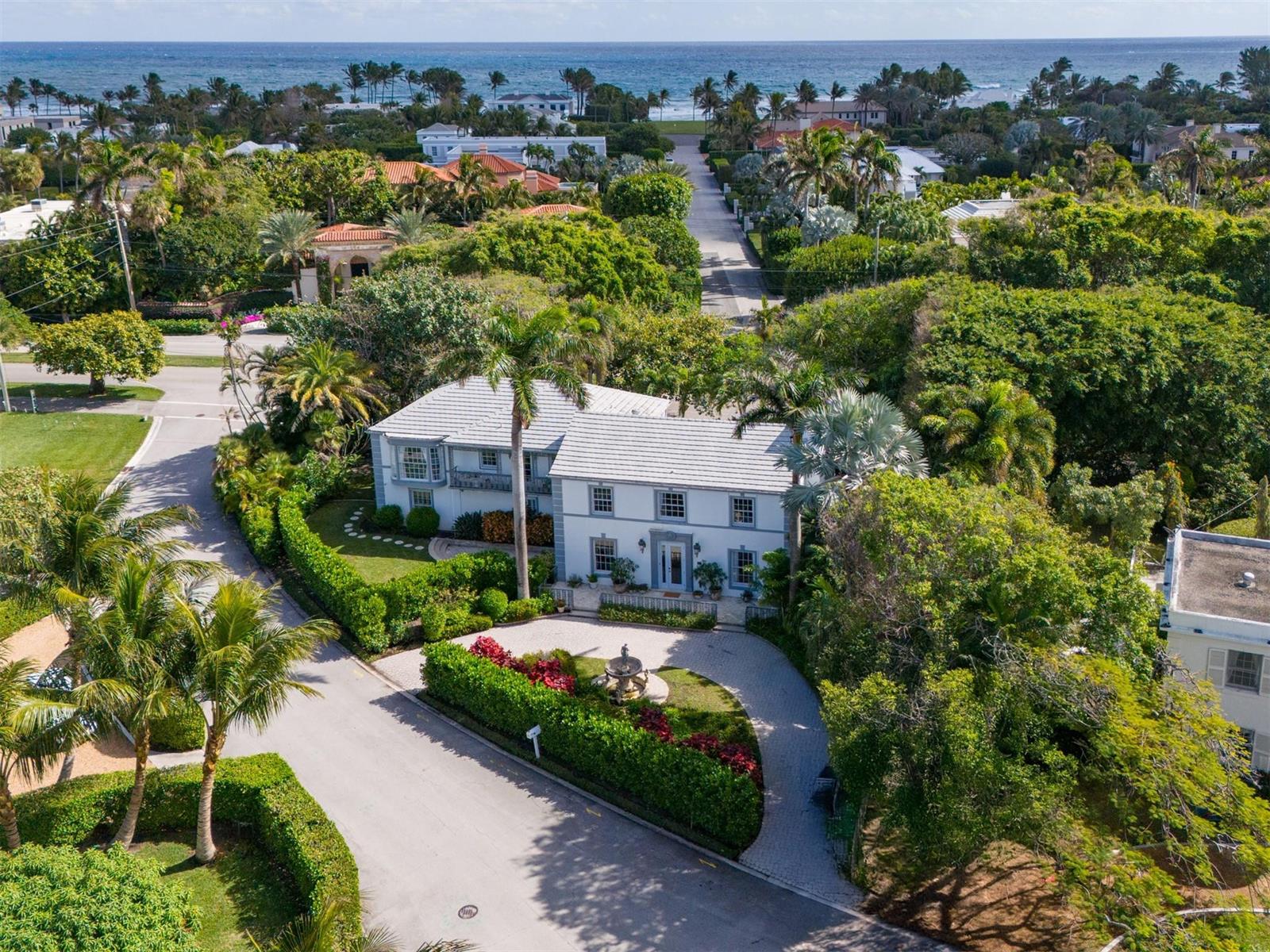 An aerial view of a white two-story house with a circular driveway and lush landscaping — 361 Crescent Drive, Palm Beach FL 33480, PALM BEACH, FL