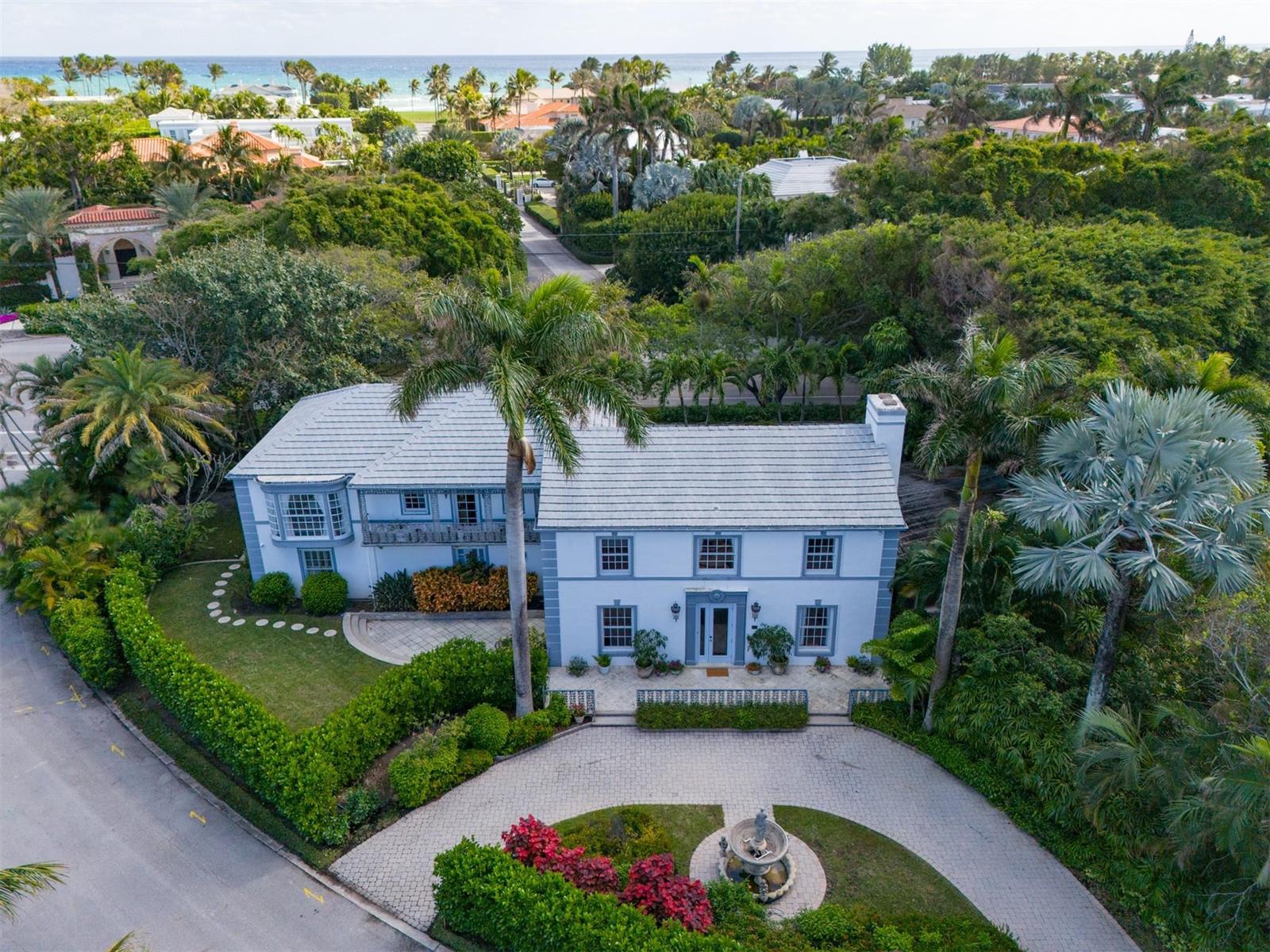 An aerial view of a two-story white house with a circular driveway and a fountain — 361 Crescent Drive, Palm Beach FL 33480, PALM BEACH, FL