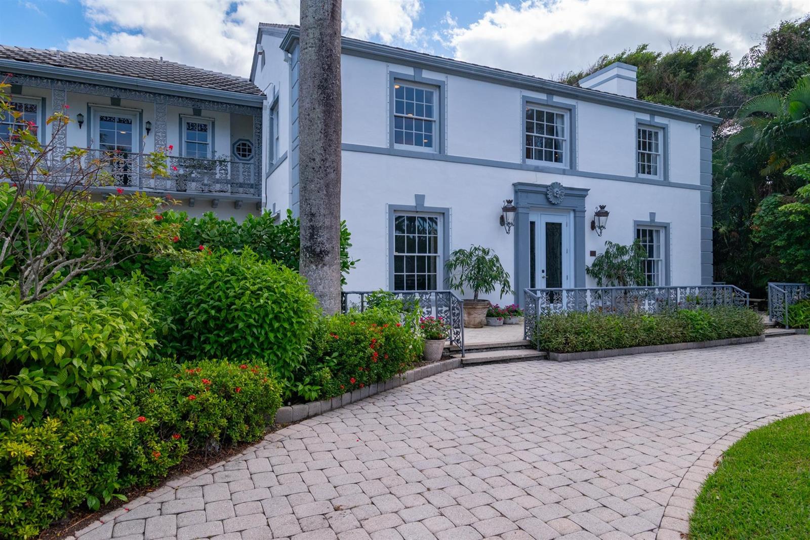 A two-story white house with gray trim, a paved driveway, and lush landscaping — 361 Crescent Drive, Palm Beach FL 33480, PALM BEACH, FL