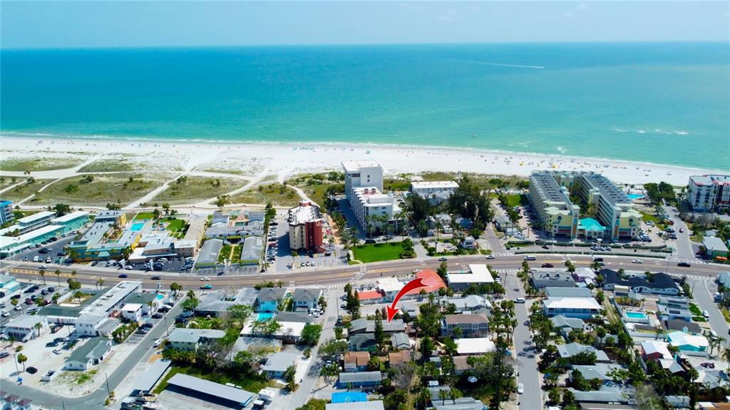 An aerial view of a beachfront resort area with a red arrow pointing to buildings — 112 119TH AVENUE, TREASURE ISLAND, FL