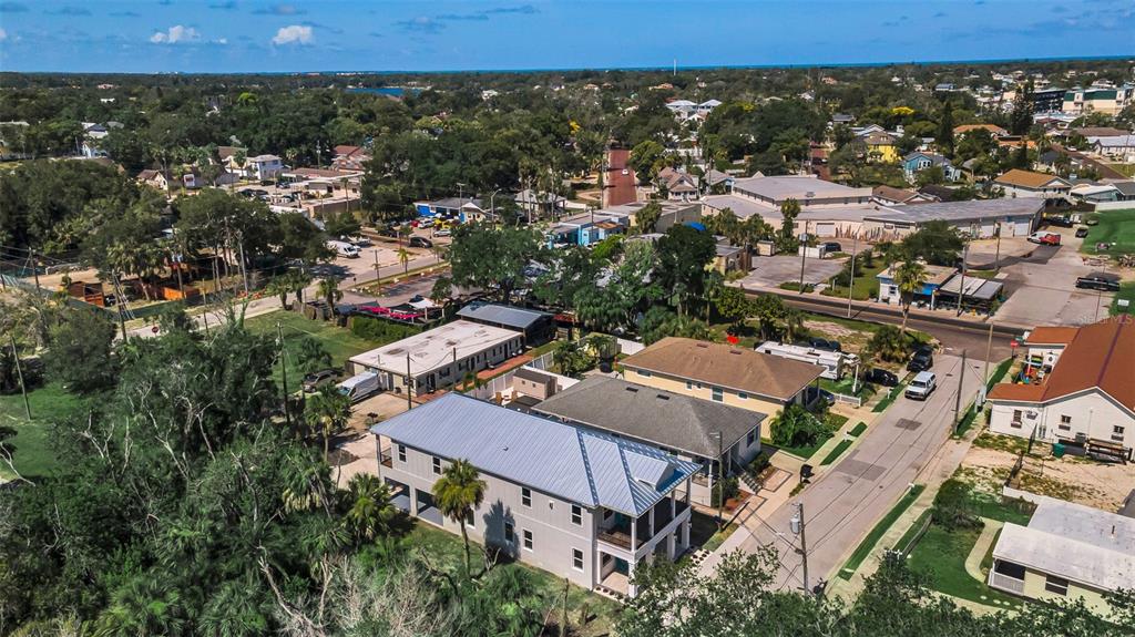 An aerial view shows a residential neighborhood with a two-story house in the foreground — 158 E SPRUCE STREET, TARPON SPRINGS, FL