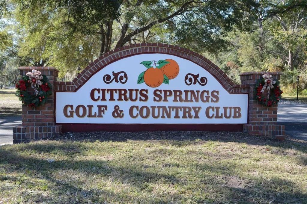 A brick monument sign displays the name Citrus Springs Golf & Country Club — 6975 N LIME DRIVE, CITRUS SPRINGS, FL