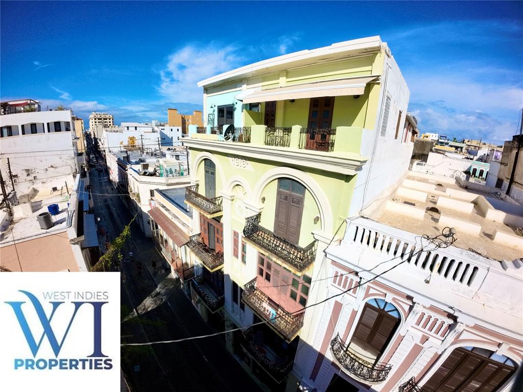 An aerial view of a historic multi-story building with balconies and a light green facade — 351 FORTALEZA UNIT 7, SAN JUAN, PR