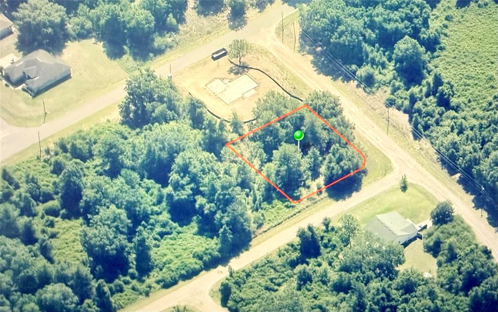 An aerial view shows a wooded, rectangular plot of land outlined in red — 689 E HOPE PLACE, CITRUS SPRINGS, FL