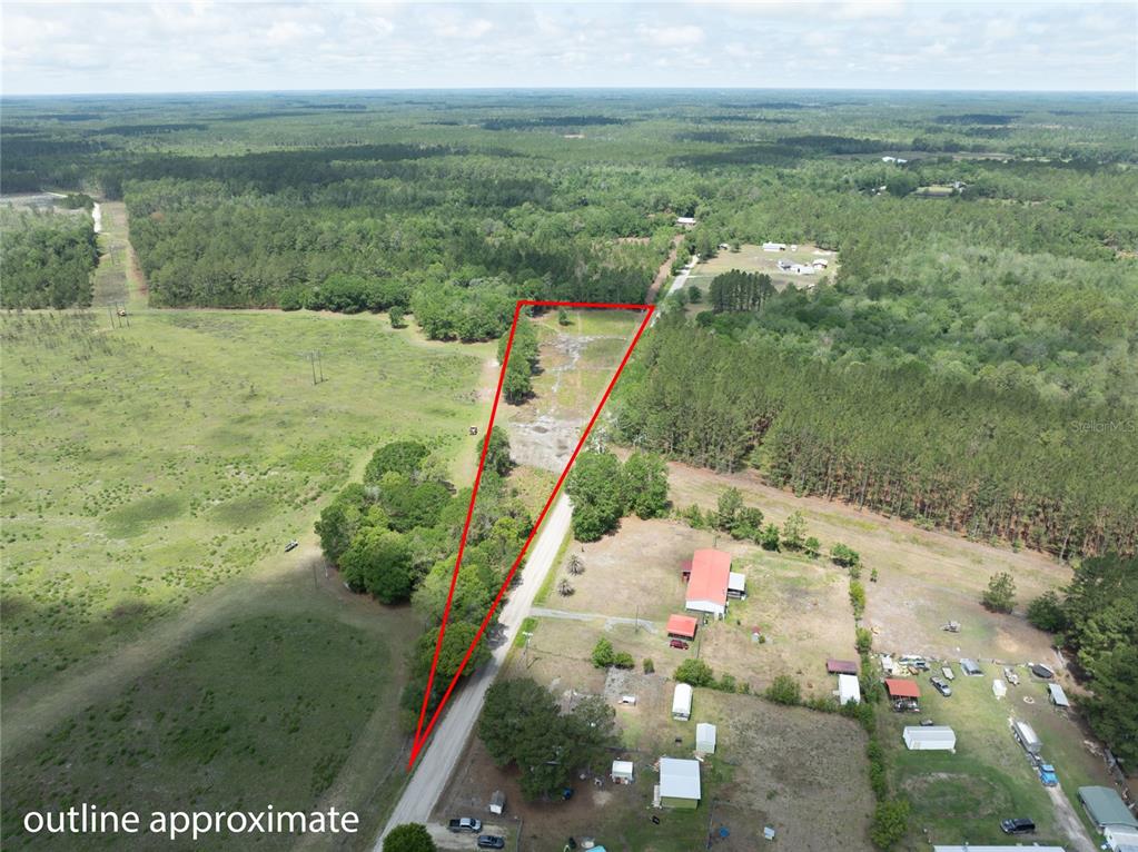 An aerial view shows a triangular plot of land outlined in red near a road — NW 185TH STREET, STARKE, FL
