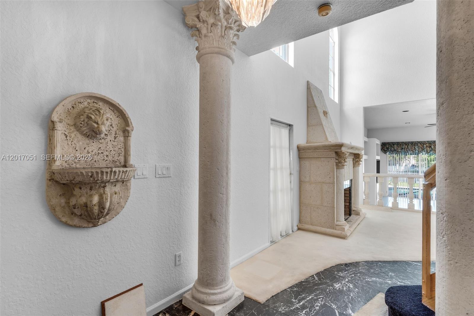 A room features a stone lion fountain, a classical column, and a stone fireplace — 14876 SW 132nd Ave, Miami FL 33186, MIAMI, FL