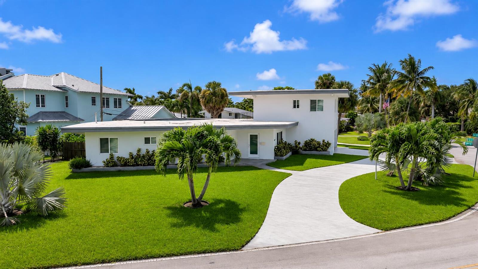 A white, flat-roofed house with a curved concrete driveway and palm trees on a lawn — 2812 NE 27th Street, Lighthouse Point FL 33064, LIGHTHOUSE POINT, FL