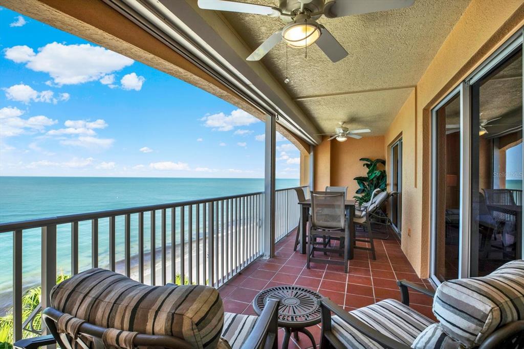 A balcony with tile flooring, outdoor furniture, and ceiling fans overlooks the ocean — 16450 GULF BOULEVARD UNIT 763, NORTH REDINGTON BEACH, FL