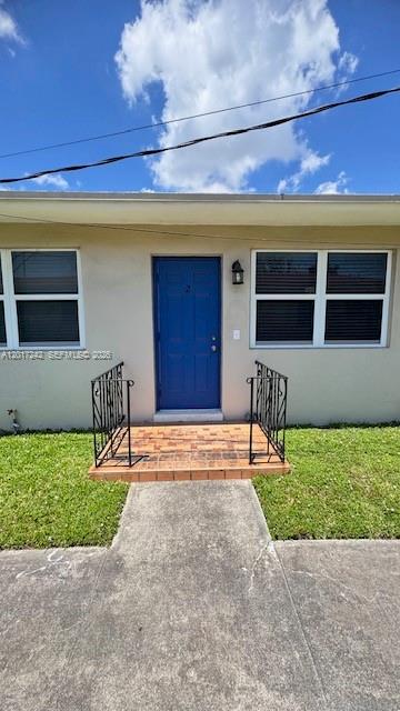 A blue front door with a small brick porch and black metal railings — 3085 W Flagler St # 2, Miami FL 33135, MIAMI, FL