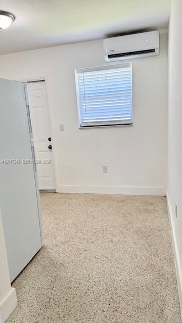 A room with a white door, a window with blinds, and a wall-mounted air conditioner — 3085 W Flagler St # 2, Miami FL 33135, MIAMI, FL