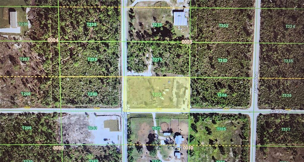 An aerial map view highlights a rectangular plot of land situated at a road intersection — 29290 CLARA DRIVE, PUNTA GORDA, FL