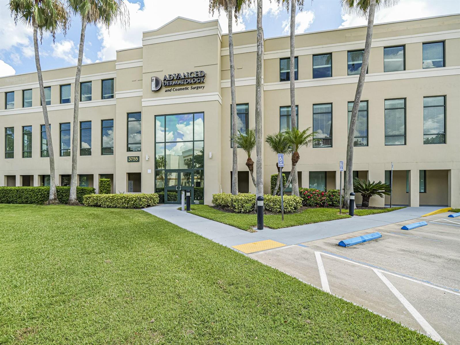 A three-story commercial building with palm trees and a parking lot in the foreground — 3755 37th Terrace, Vero Beach FL 32960, VERO BEACH, FL