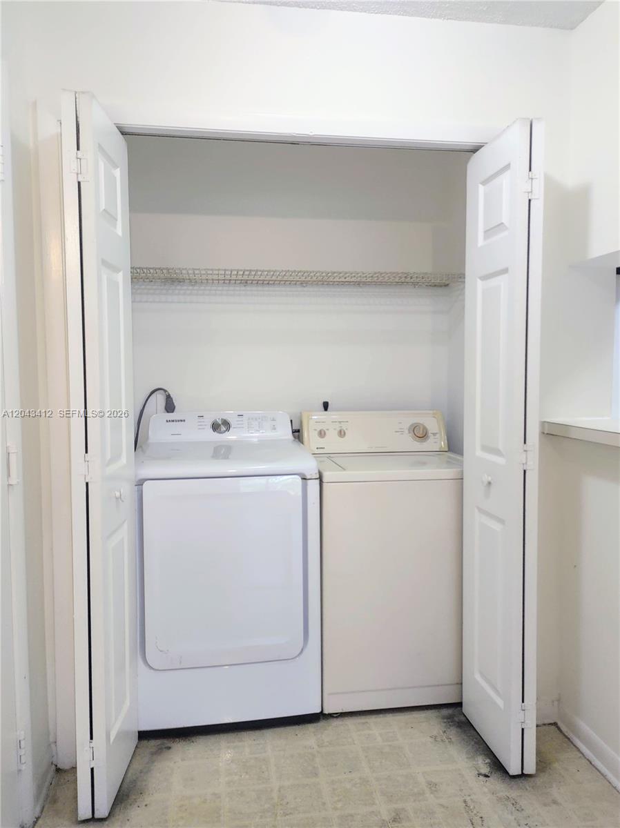 A laundry closet contains a white Samsung washing machine and a beige dryer — 4241 W Mcnab Rd # 27, Pompano Beach FL 33069, POMPANO BEACH, FL