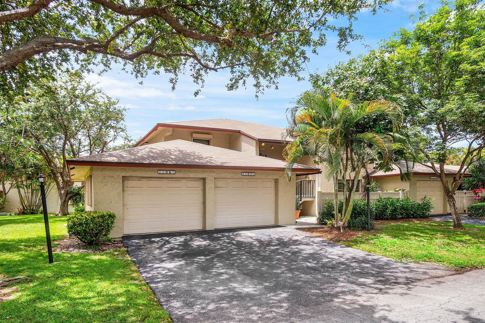 A two-story residential building features two garage doors and a paved driveway — 1779 NE 39th Court # 1106, Pompano Beach FL 33064, POMPANO BEACH, FL