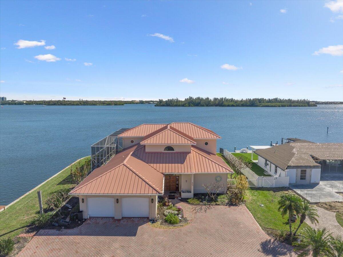 An aerial view of a two-story house with a metal roof and a brick driveway — 2 Seahorse Lane, Vero Beach FL 32960, VERO BEACH, FL