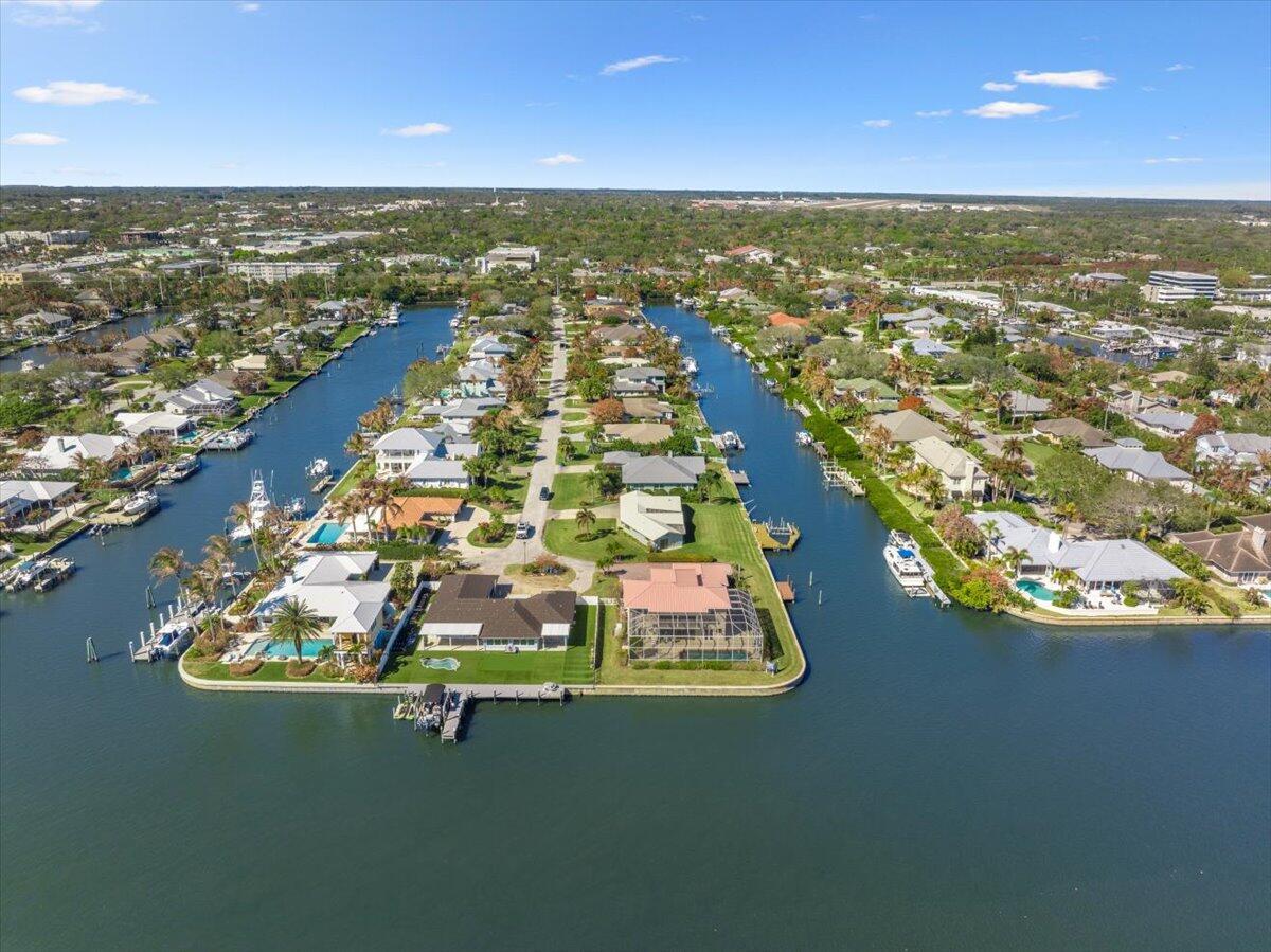 An aerial view shows waterfront homes with private docks along a canal in a neighborhood — 2 Seahorse Lane, Vero Beach FL 32960, VERO BEACH, FL