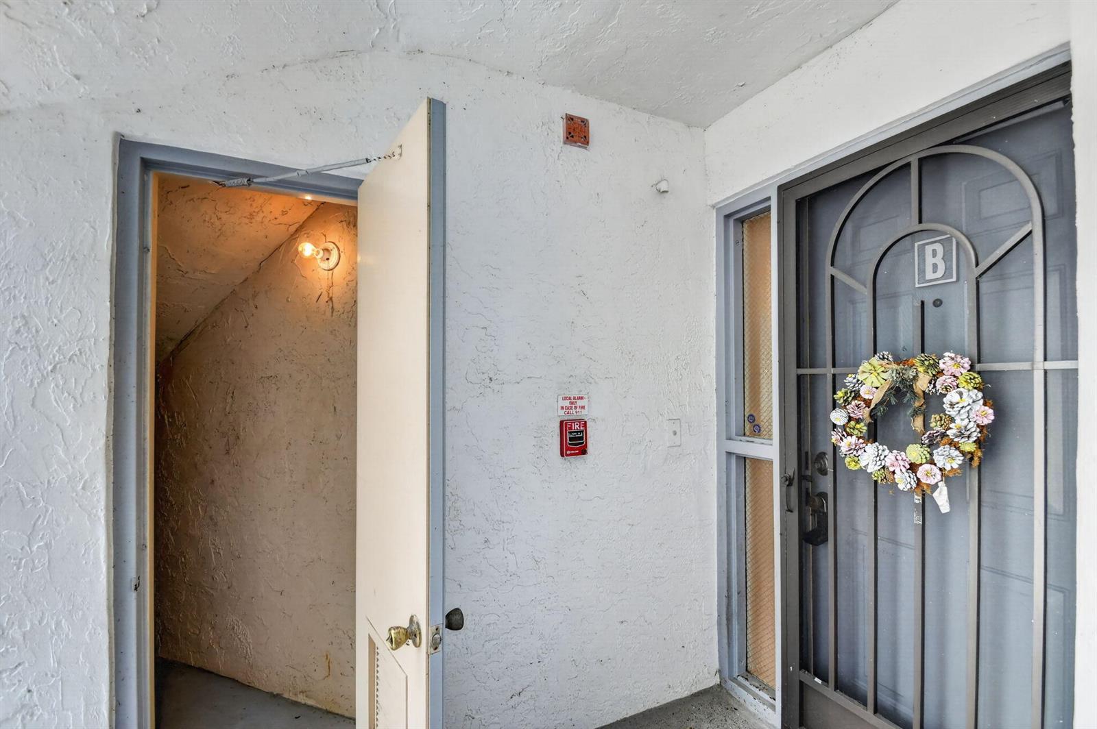 An open door leads to a small utility space next to a front door marked B — 5395 Firenze Drive # B, Boynton Beach FL 33437, BOYNTON BEACH, FL