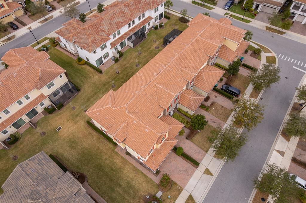 An aerial view shows a multi-unit townhouse building with a terracotta tile roof — 14044 MILLINGTON STREET, ORLANDO, FL