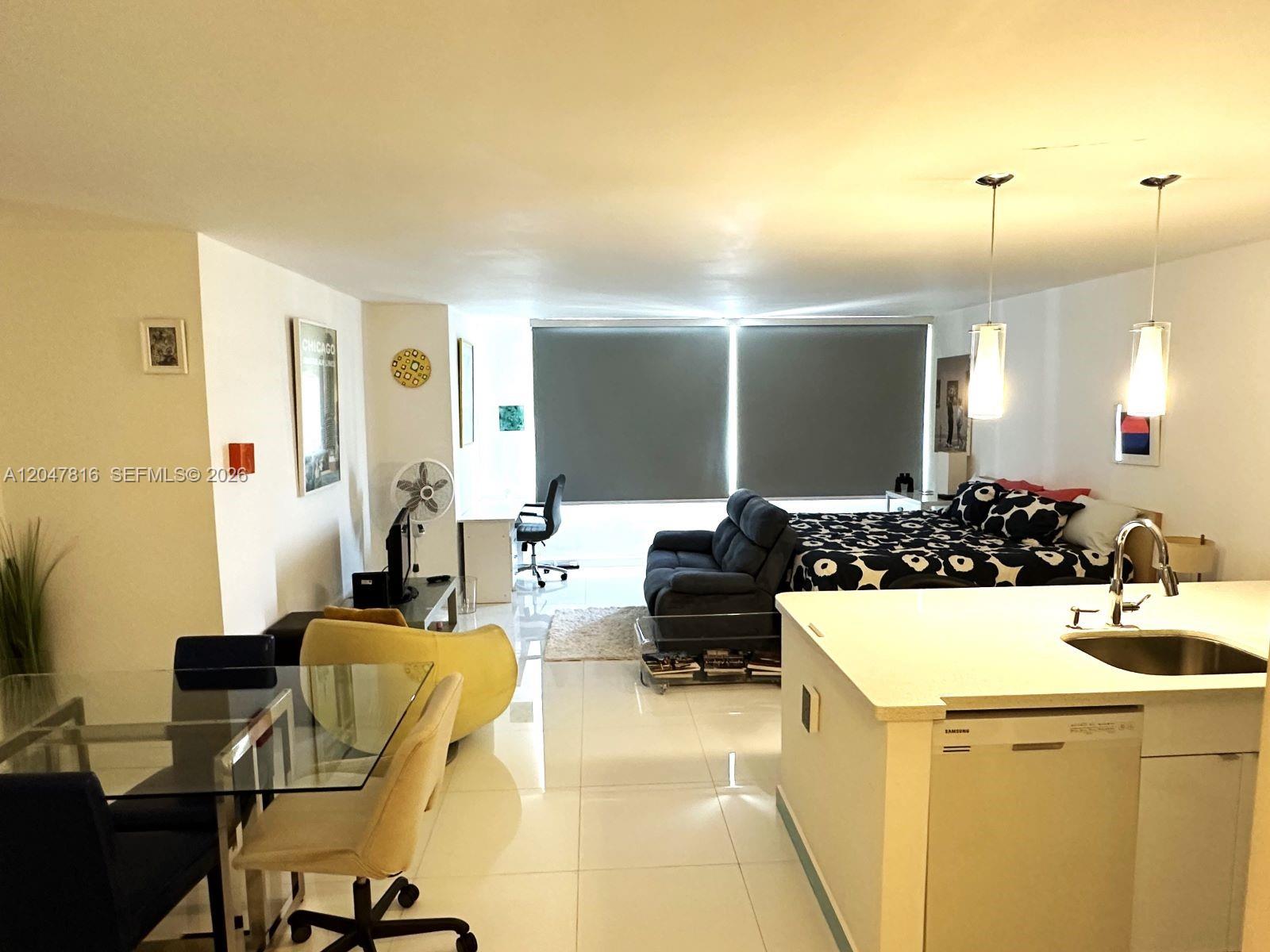 A studio apartment features a kitchen island, dining area, living space, and bedroom area — 1000 West Ave # 1532, Miami Beach FL 33139, MIAMI BEACH, FL