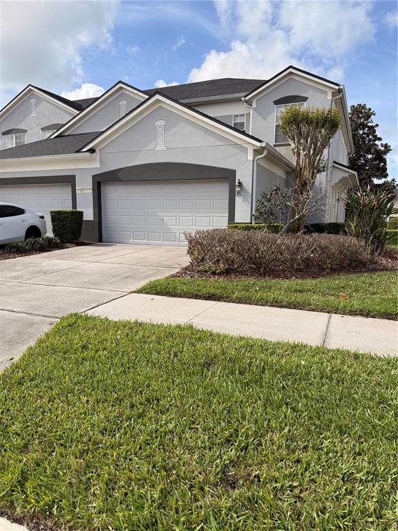 A two-story gray house with a two-car garage and a manicured front lawn — 1178 SHALLCROSS AVENUE, ORLANDO, FL