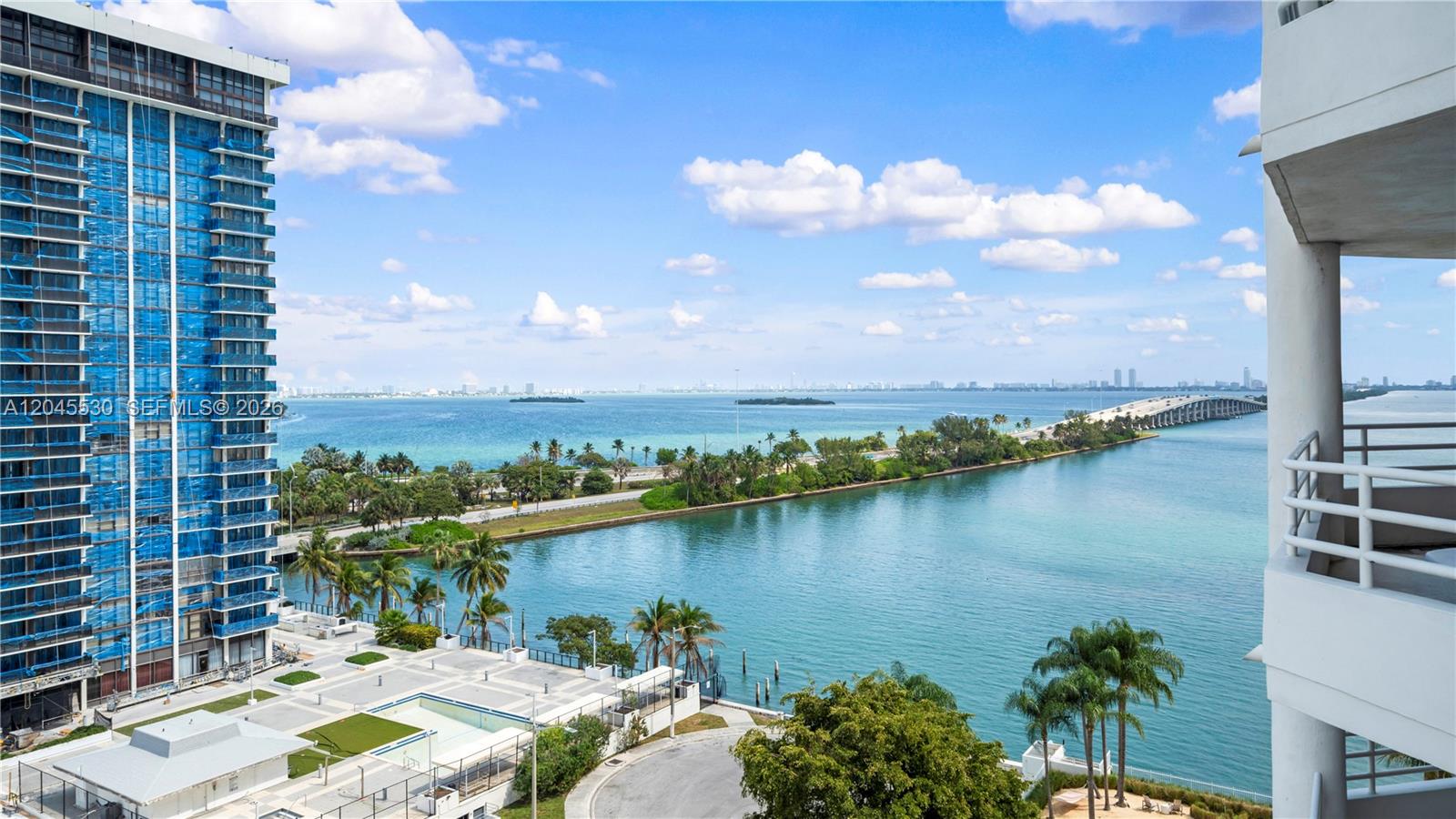 An elevated view shows a coastal high-rise, a bridge, and a swimming pool area — 555 NE 34th St # 2704, Miami FL 33137, MIAMI, FL