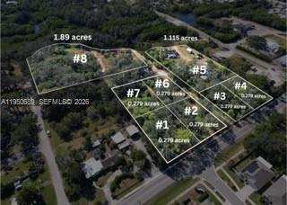 An aerial view shows a map overlay outlining several numbered land parcels for sale — 301 E Shell Point Road #77, Tampa FL 33570, TAMPA, FL