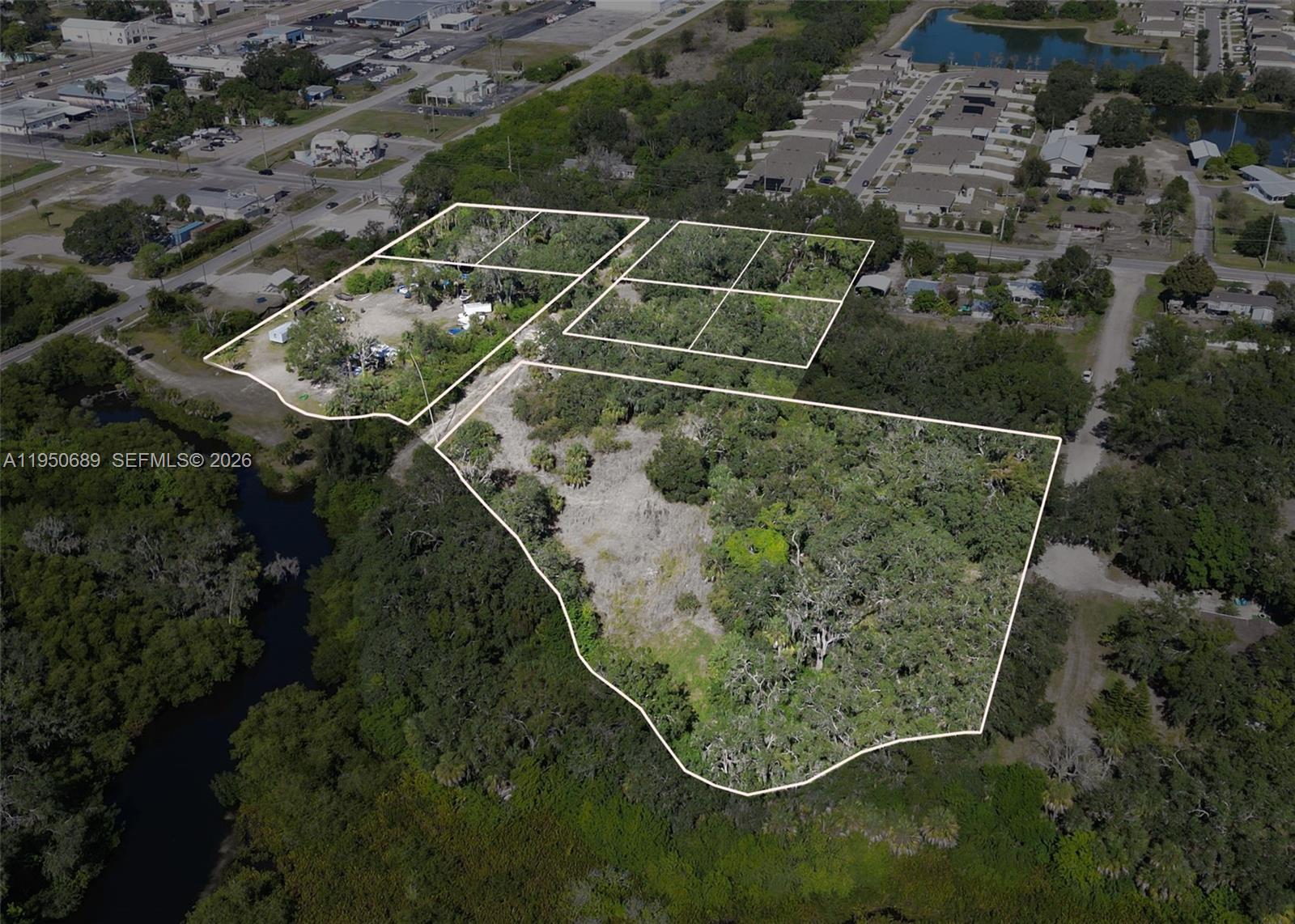 An aerial view shows several adjacent plots of land outlined in white — 301 E Shell Point Road #77, Tampa FL 33570, TAMPA, FL
