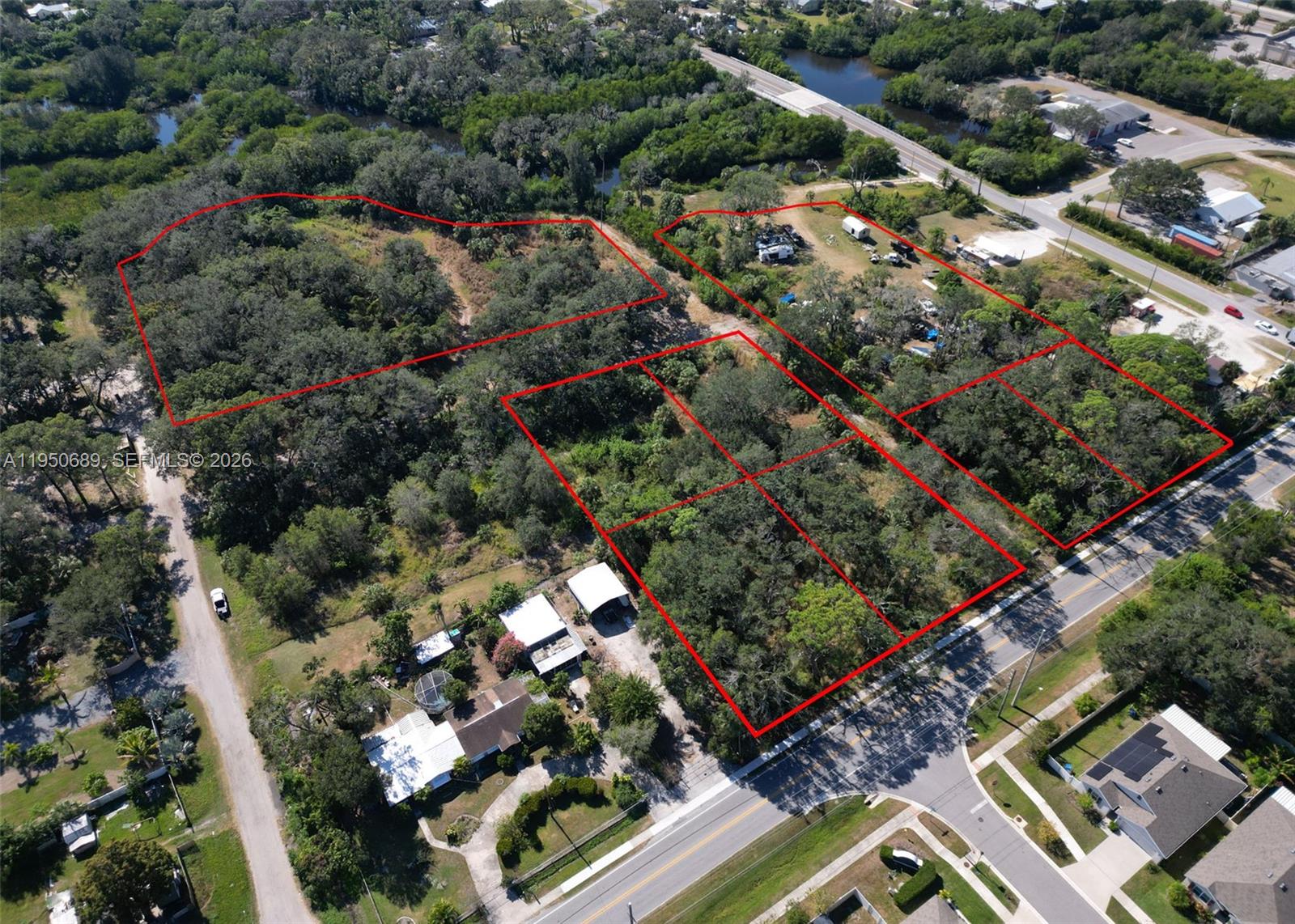 An aerial view shows several wooded lots outlined in red near a paved road — 301 E Shell Point Road #77, Tampa FL 33570, TAMPA, FL