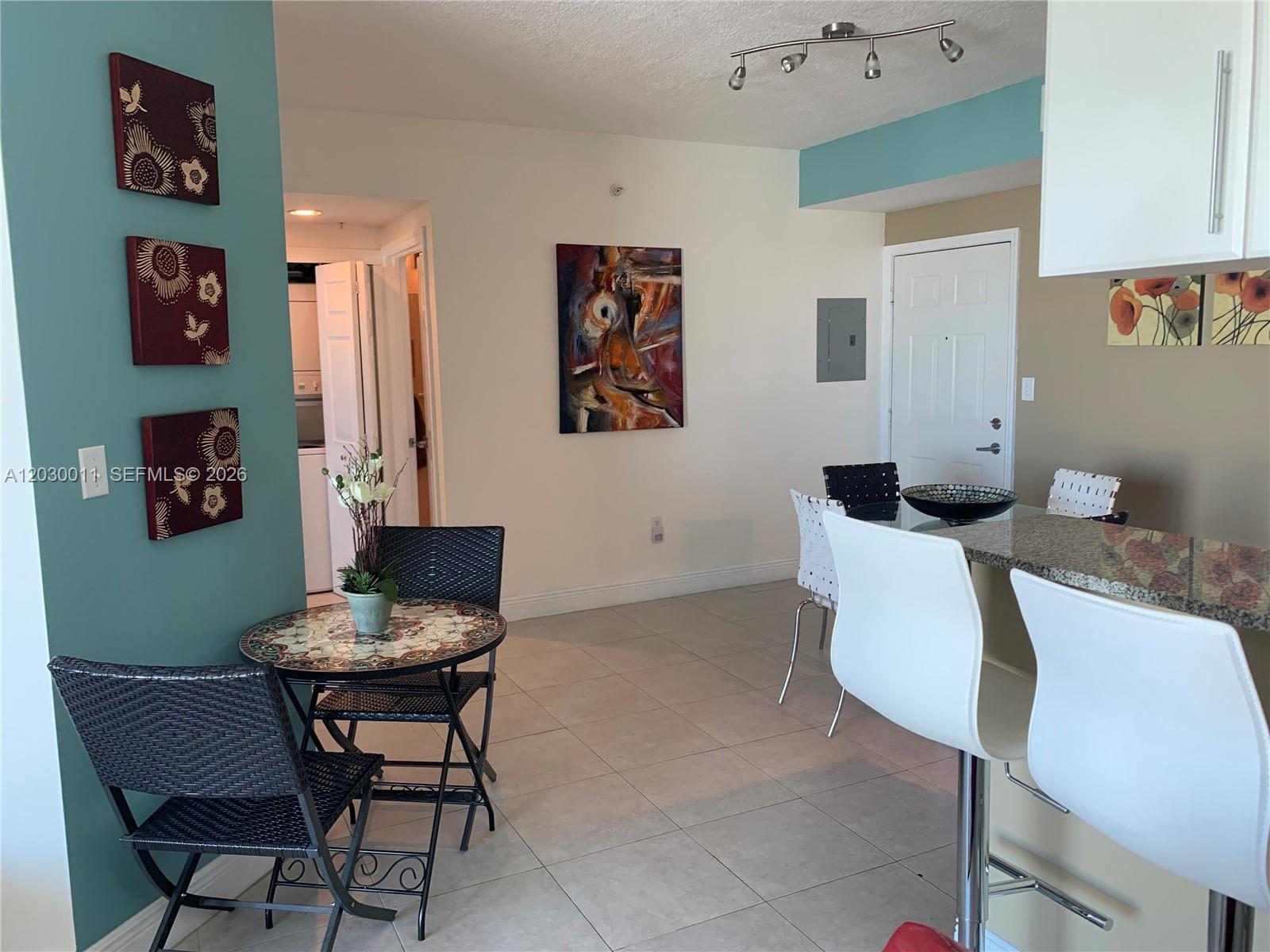 A balcony view overlooks a city street, green space, and high-rise buildings near the water — 275 NE 18th # 1709, Miami FL 33132, MIAMI, FL