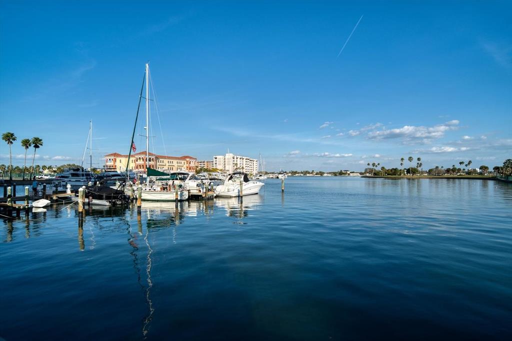 A marina with several docked sailboats and motorboats under a clear blue sky — 10355 PARADISE BOULEVARD UNIT 612, TREASURE ISLAND, FL