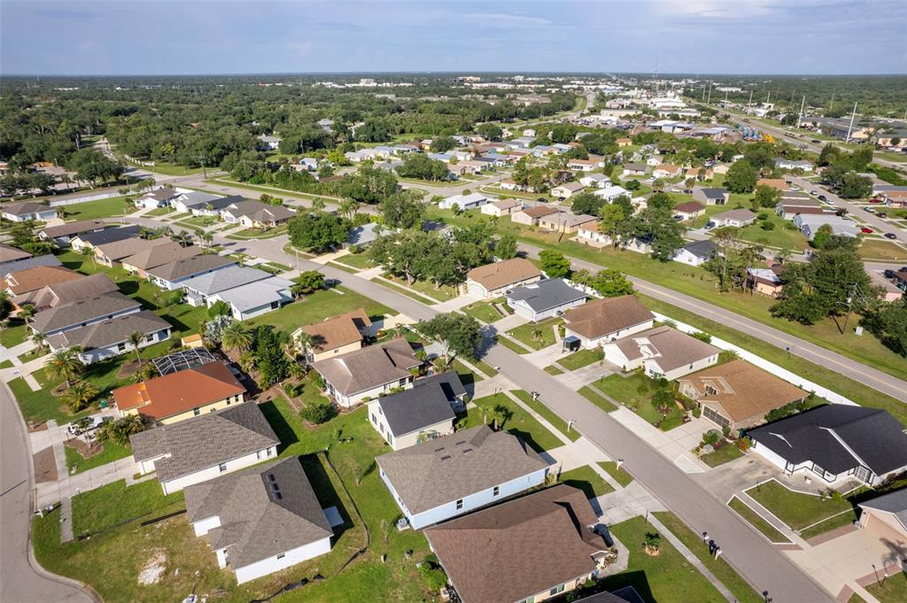 A blue single-story house with a two-car garage and a concrete driveway — 605 ROSE APPLE CIRCLE, PORT CHARLOTTE, FL
