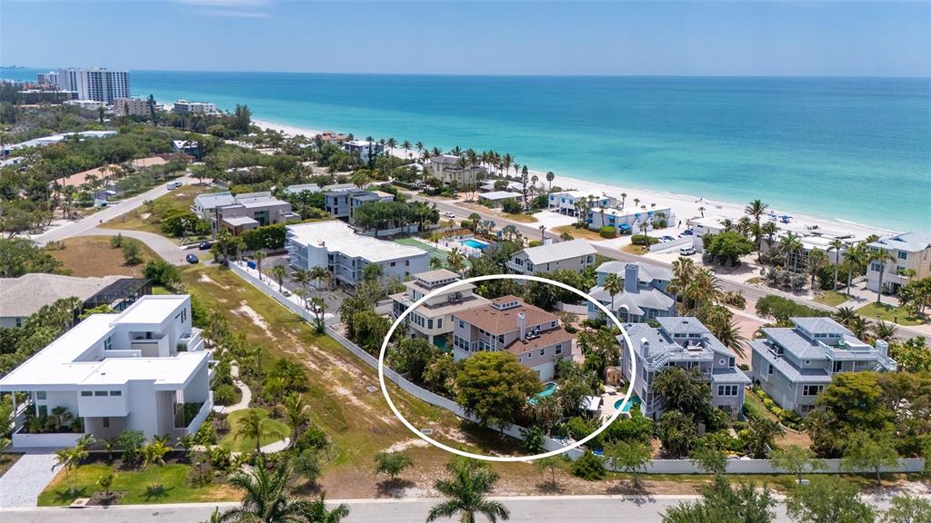 An aerial view shows a multi-story house with a pool, surrounded by coastal neighborhood homes — 3040 GULF OF MEXICO DRIVE UNIT 3, LONGBOAT KEY, FL