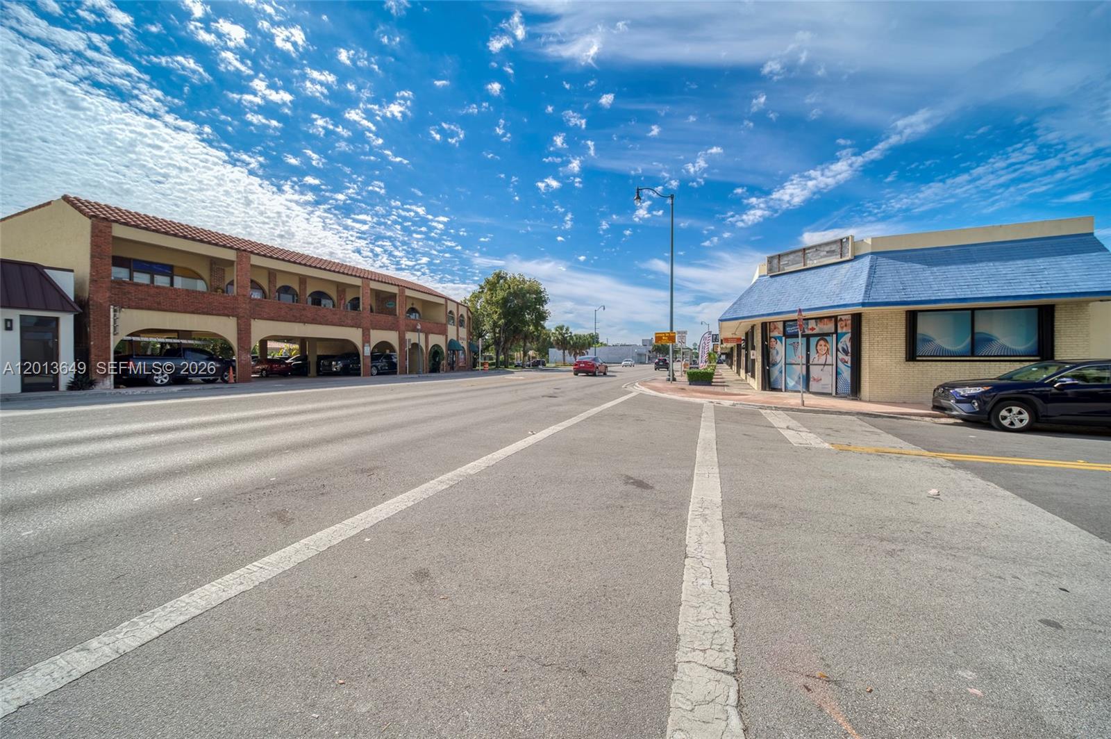 A street view shows a multi-story brick building with covered parking and a corner storefront — 5301 SW 8th St, Miami FL 33134, MIAMI, FL