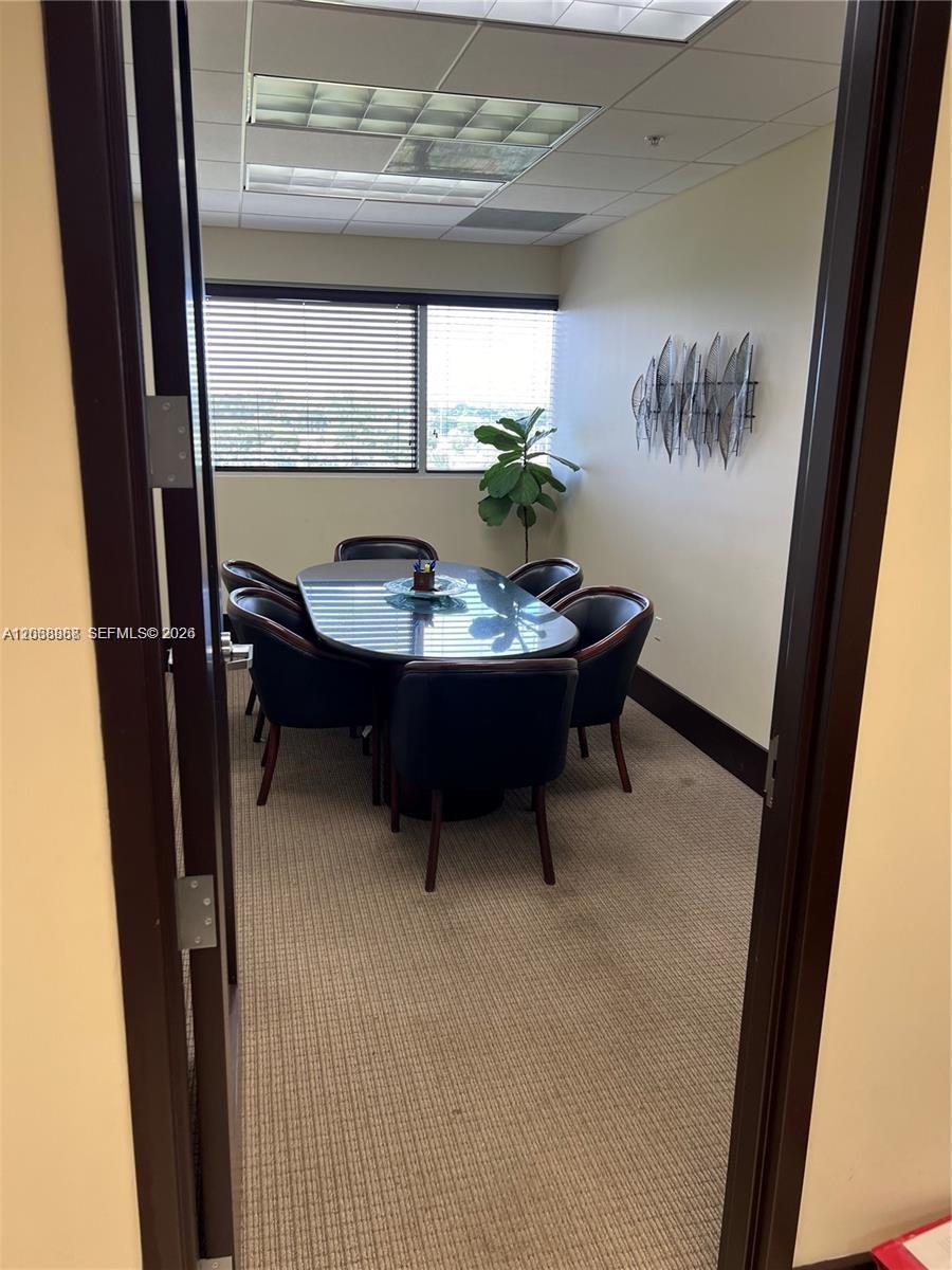 A small conference room features a glass-topped oval table, six chairs, and a window — 7480 SW 40th St # 750, Miami FL 33155, MIAMI, FL