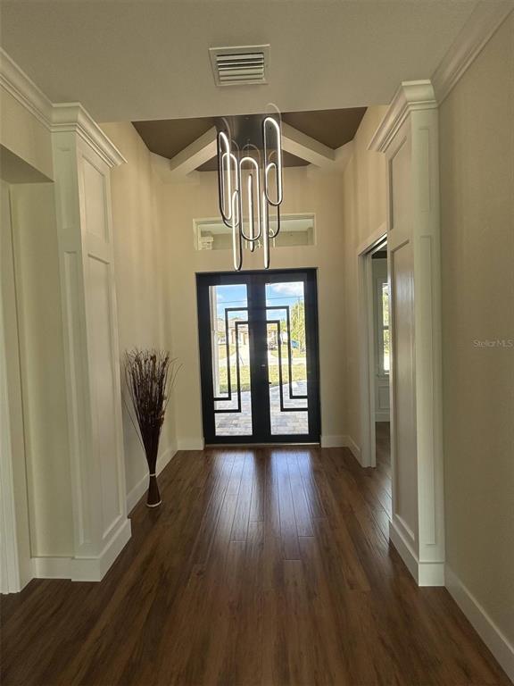 A single-story house with a three-car garage, stone accents, and a paved driveway — 1126 ARREDONDO STREET, NORTH PORT, FL