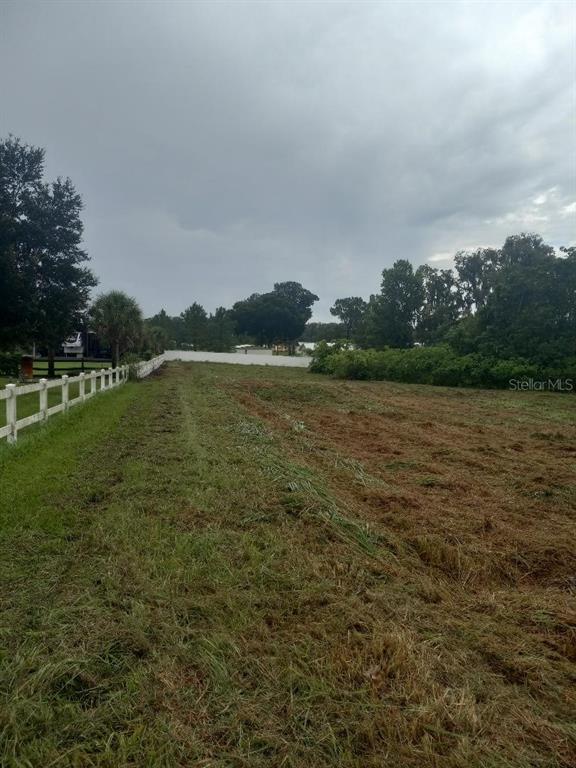 A grassy, partially cleared lot features a white fence along the left side — 3408 N FORBES ROAD, PLANT CITY, FL