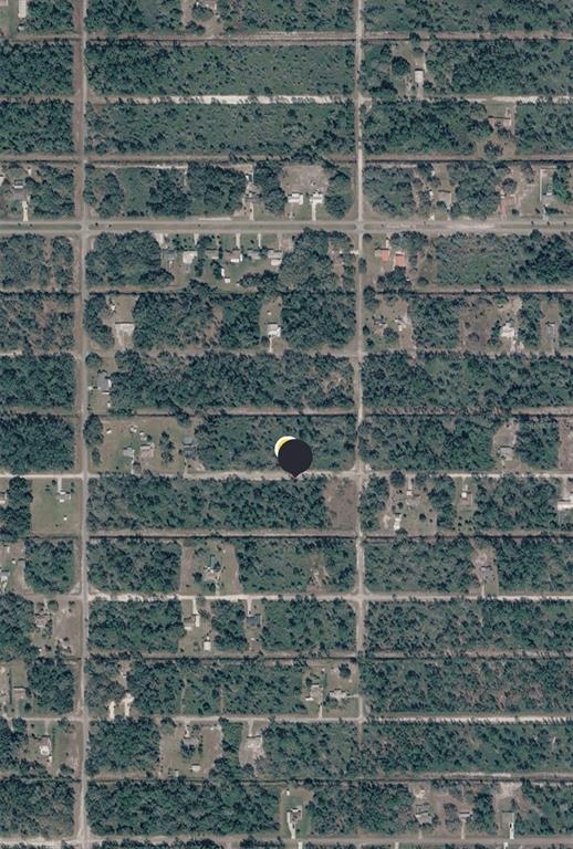 An aerial view of a grid-patterned residential area with wooded lots and scattered houses — 906 GRANADA DRIVE, INDIAN LAKE ESTATES, FL