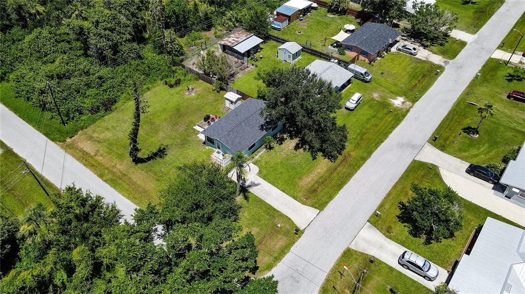 An aerial view shows a single-story house with a gray roof and a large backyard — 8382 OSPREY ROAD, ENGLEWOOD, FL
