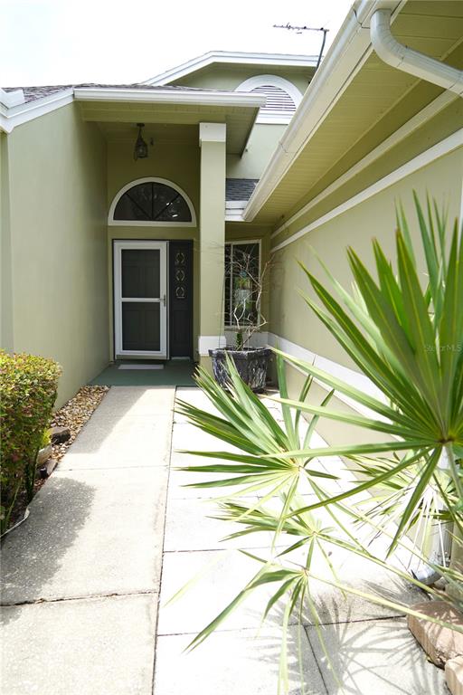 A concrete walkway leads to the front entrance of a light green house — 4304 BARRET AVENUE, PLANT CITY, FL