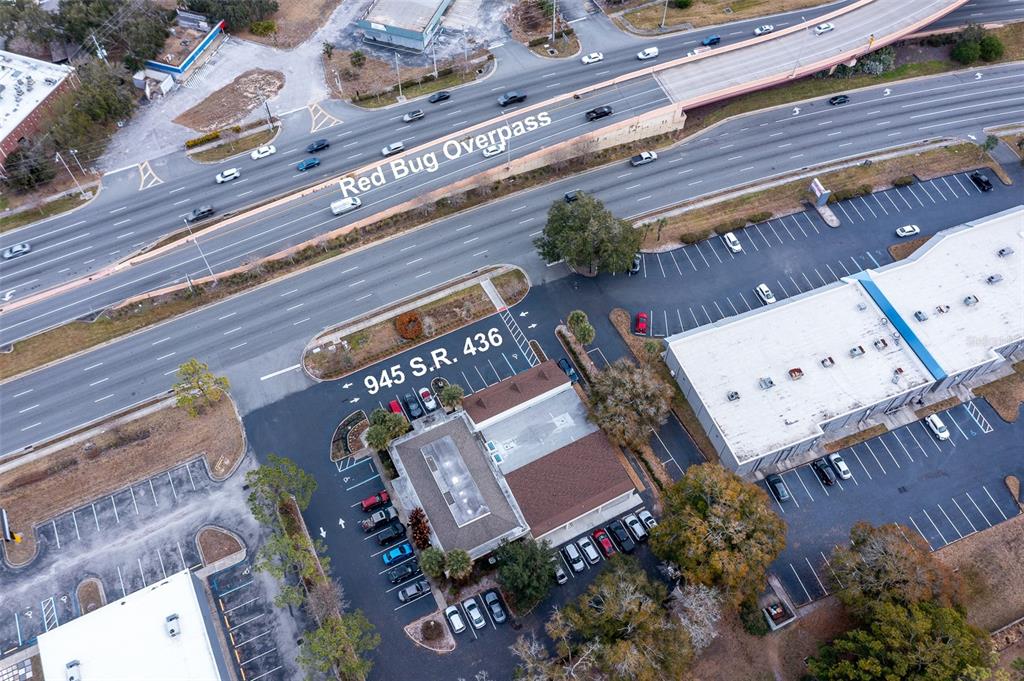 An aerial view shows a commercial building with a parking lot next to a highway — 945 STATE ROAD 436 UNIT B and C, CASSELBERRY, FL